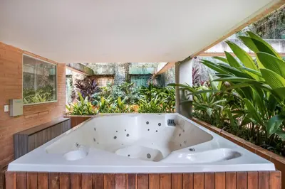 a bath tub in a room with plants at Luxury Apartment Poblado in Medellín