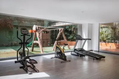 a gym with two treadmills and two tread machines at Luxury Apartment Poblado in Medellín