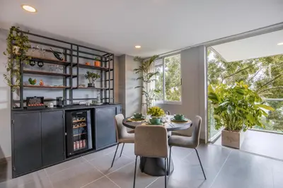 a dining room with a table and chairs and a window at Luxury Apartment Poblado in Medellín