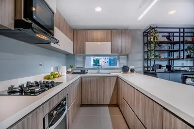 a kitchen with wooden cabinets and a counter top at Luxury Apartment Poblado in Medellín