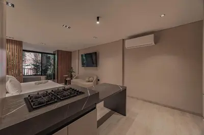 a kitchen with a stove top oven in a room at Premium Smart Loft with Alexa in El Poblado in Medellín