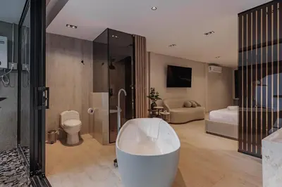 a bathroom with a bath tub and a bedroom at Premium Smart Loft with Alexa in El Poblado in Medellín