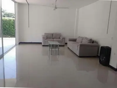 a living room with two couches and a table at Serenity Poolside Retreat in Santa Fe Villa Bonita in Santa Fe de Antioquia