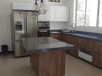 a kitchen with a counter top and a refrigerator at Serenity Poolside Retreat in Santa Fe Villa Bonita in Santa Fe de Antioquia