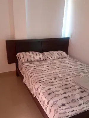 a bed in a bedroom with a brown headboard at Serenity Poolside Retreat in Santa Fe Villa Bonita in Santa Fe de Antioquia