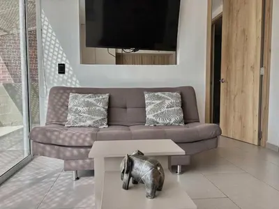 a living room with a couch and a table at Comfy Loft near El Tesoro MDE OSLO in Medellín