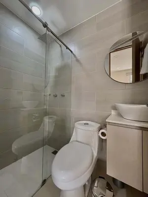 a bathroom with a toilet and a glass shower at Comfy Loft near El Tesoro MDE OSLO in Medellín