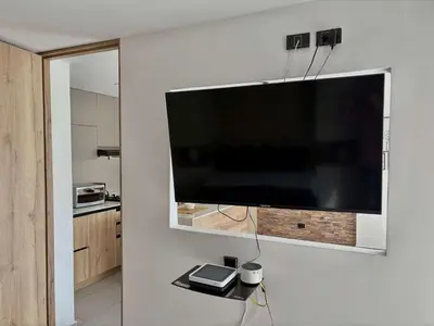 a large flat screen tv hanging on a wall at Comfy Loft near El Tesoro MDE OSLO in Medellín