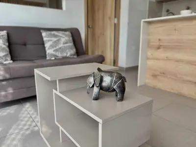 a small elephant statue sitting on a table in a living room at Comfy Loft near El Tesoro MDE OSLO in Medellín