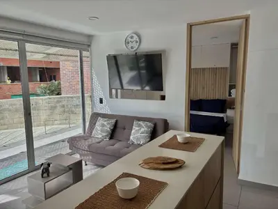 a living room with a couch and a table at Comfy Loft near El Tesoro MDE OSLO in Medellín