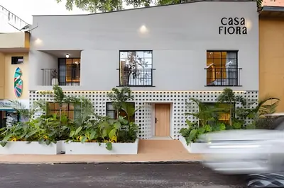 a white building with plants in front of it at Casa Fiora Oasis in Medellín