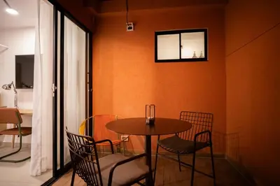 a dining room with a table and chairs and a window at 201 Stylish Retreat in Laureles Area Terrace AC in Medellín