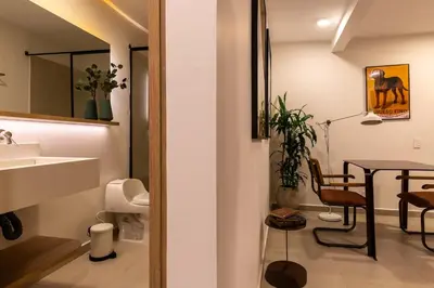 a bathroom with a sink and a table in a room at 201 Stylish Retreat in Laureles Area Terrace AC in Medellín
