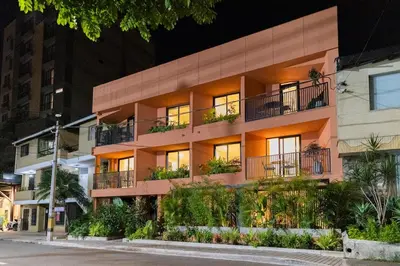an apartment building on a city street at night at 201 Stylish Retreat in Laureles Area Terrace AC in Medellín