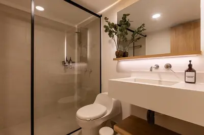 a bathroom with a toilet and a sink and a shower at 202 Modern Stay in Laureles Area Cozy Balcony AC in Medellín