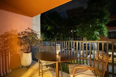 a table and chairs on a balcony with a table at 202 Modern Stay in Laureles Area Cozy Balcony AC in Medellín
