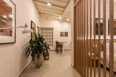 a hallway with a bed and a potted plant at 301 Live Local Balcony Loft in Vibrant Laureles area in Medellín
