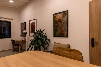 a room with a table and chairs and a painting on the wall at 301 Live Local Balcony Loft in Vibrant Laureles area in Medellín