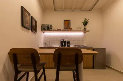 a kitchen with two chairs and a counter top at 301 Live Local Balcony Loft in Vibrant Laureles area in Medellín