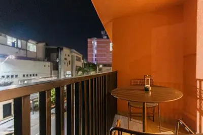 a table on a balcony with a view of a city at 301 Live Local Balcony Loft in Vibrant Laureles area in Medellín