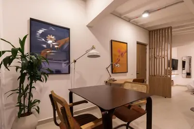 a dining room with a table and a plant at 303 Balance and Design Loft with AC in Laureles area in Medellín