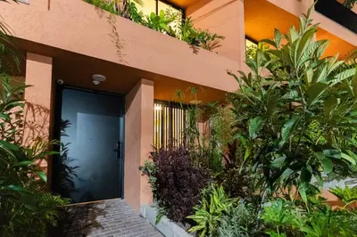 a front door of a house with plants at 303 Balance and Design Loft with AC in Laureles area in Medellín