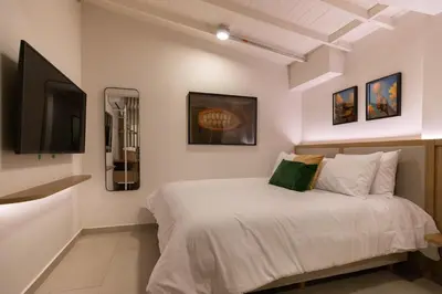 a bedroom with a bed and a flat screen tv at 303 Balance and Design Loft with AC in Laureles area in Medellín