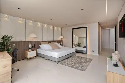 a bedroom with a white bed and a room with a mirror at Mansión en las palmas Pool ,Jacuzzi,View in Medellín