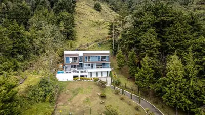 an aerial view of a house on a hill at Mansión en las palmas Pool ,Jacuzzi,View in Medellín