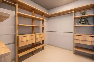 a walk in closet with wooden shelves at Mansión en las palmas Pool ,Jacuzzi,View in Medellín
