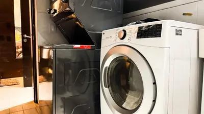 a washing machine sitting next to a refrigerator at Mansión en las palmas Pool ,Jacuzzi,View in Medellín