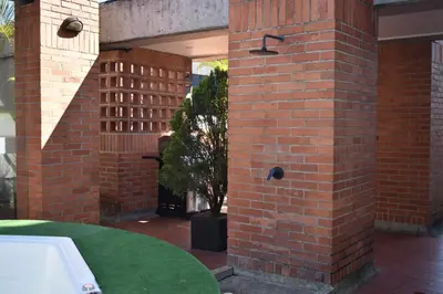 a brick wall with a tree in a courtyard at Loft comodo y central con AC y Terraza propia en Astorga Poblado in Medellín