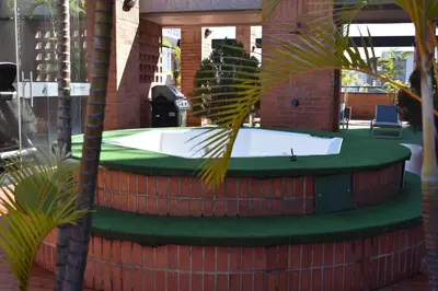 a hot tub in a building with palm trees at Loft comodo y central con AC y Terraza propia en Astorga Poblado in Medellín