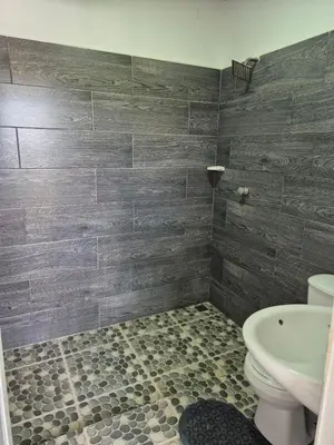 a bathroom with a toilet and a sink at Villa Paraíso Nápoles in Doradal