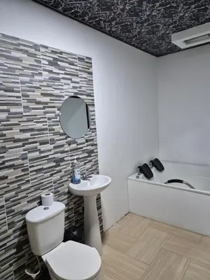 a bathroom with a toilet and a sink and a mirror at Villa Paraíso Nápoles in Doradal