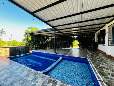 a swimming pool under awning on a house at Villa Paraíso Nápoles in Doradal