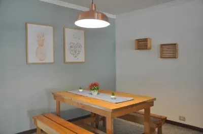 a wooden table in a room with a potted plant on it at Laureles, casa completa y amplia para grupos grandes in Medellín