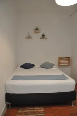 a bedroom with a bed in a room at Laureles, casa completa y amplia para grupos grandes in Medellín