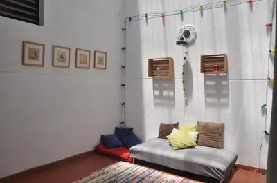 a living room with a couch with colorful pillows at Laureles, casa completa y amplia para grupos grandes in Medellín