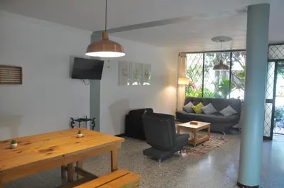a living room with a couch and a table at Laureles, casa completa y amplia para grupos grandes in Medellín