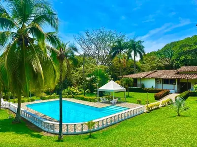 an image of a swimming pool in front of a house at Finca - Paraiso in Medellín