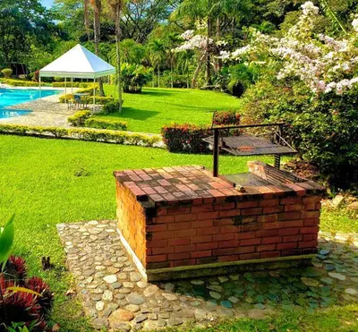 a bench and a picnic table in a yard at Finca - Paraiso in Medellín