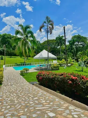 a resort with a swimming pool and a tent at Finca - Paraiso in Medellín