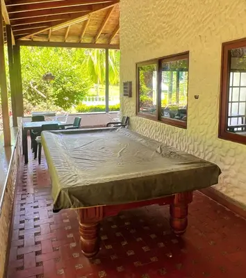 a large bed in a room with a table at Finca - Paraiso in Medellín