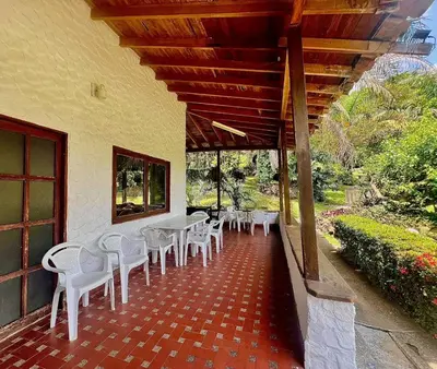 a row of tables and chairs on a patio at Finca - Paraiso in Medellín