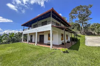 a house on top of a grassy hill at Entre Cafetales in Jardin