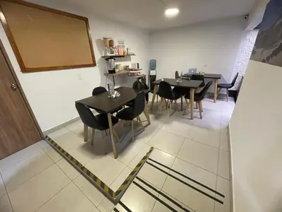 a dining room with tables and chairs and a chalkboard at Casa en Poblado para grupos in Medellín