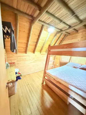a bedroom with a bed in a wooden room at Glamping en Rionegro in Rionegro