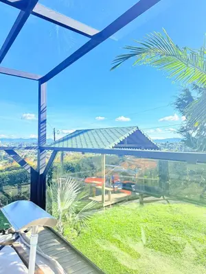a room with a chair and a large window at Glamping en Rionegro in Rionegro