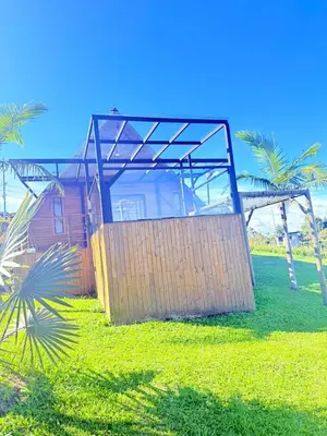 a house sitting on top of a lush green field at Glamping en Rionegro in Rionegro